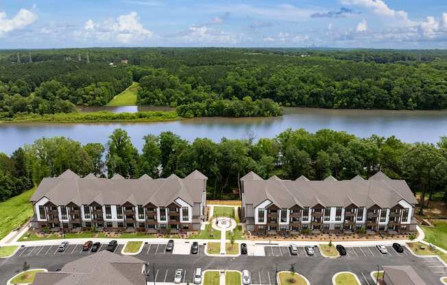 an aerial view of an apartment complex with a lake in the background