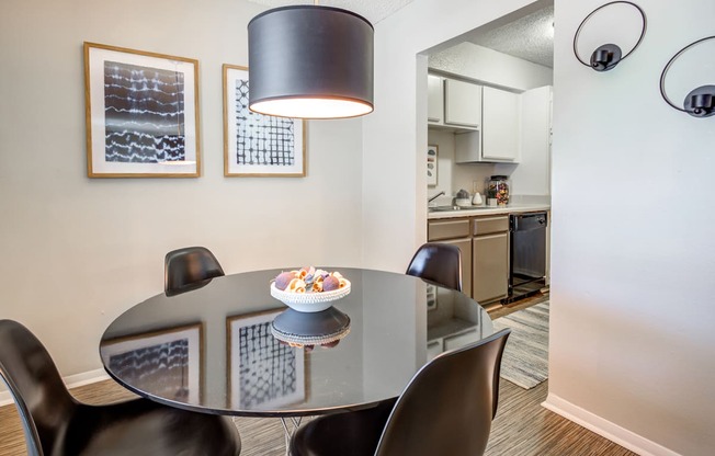 a dining room with a table and chairs and a kitchen at The Hub at Baton Rouge, Louisiana