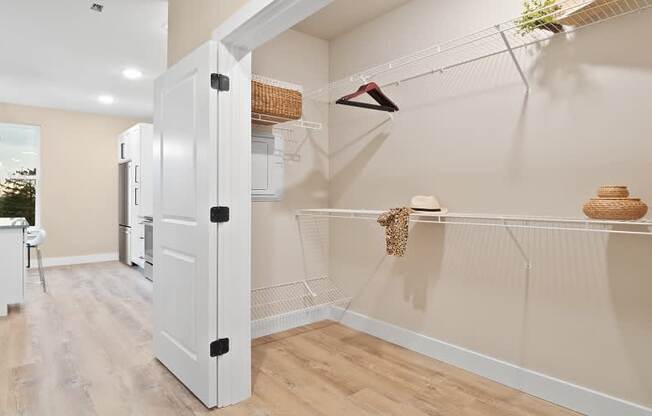 A kitchen with a white fridge and a white door is shown.