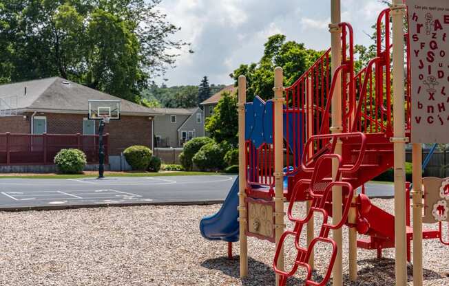 a playground with a basketball hoop in the background