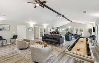 A room with a pool table and a ceiling fan.