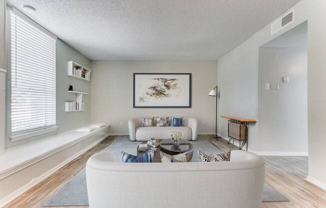 the living room of an apartment with a couch and a coffee table