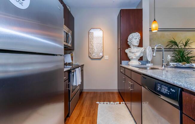 a modern kitchen with stainless steel appliances and wooden cabinets