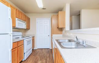 a kitchen with a stove and a refrigerator