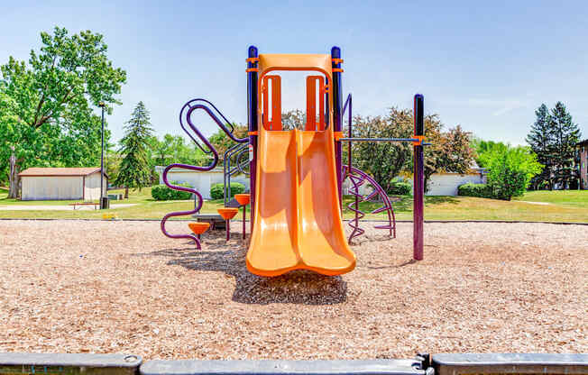 a slide on a playground at a park at Willow Hill Apartments, Justice, IL