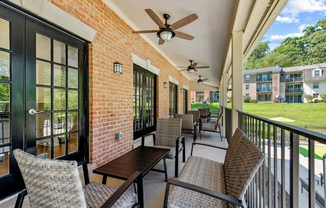 a patio with tables and chairs and a ceiling fan