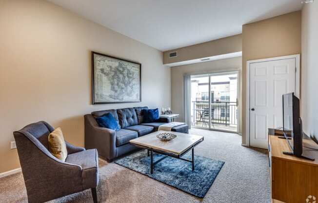 a living room with a couch and chair and a television