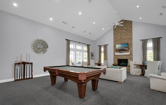 a large living room with a pool table in the middle of it