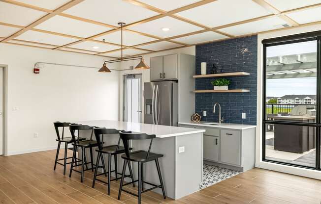 a kitchen with a white counter top and black bar stools at The Standard on 32nd, West Fargo