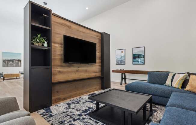 a living room with a blue couch and a television