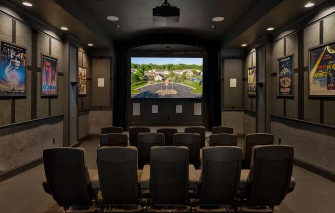 a conference room with a projector screen and chairs