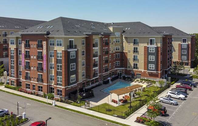 an aerial view of an apartment building with a swimming pool