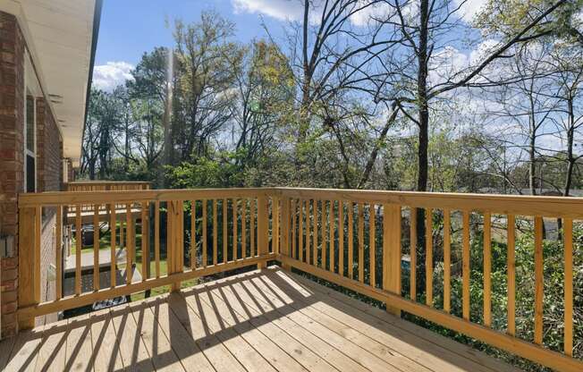 the deck has a view of the backyard and the trees