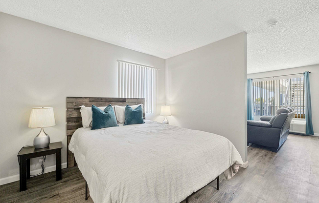 Embrace comfort in this stylish bedroom that seamlessly connects to a welcoming living area.