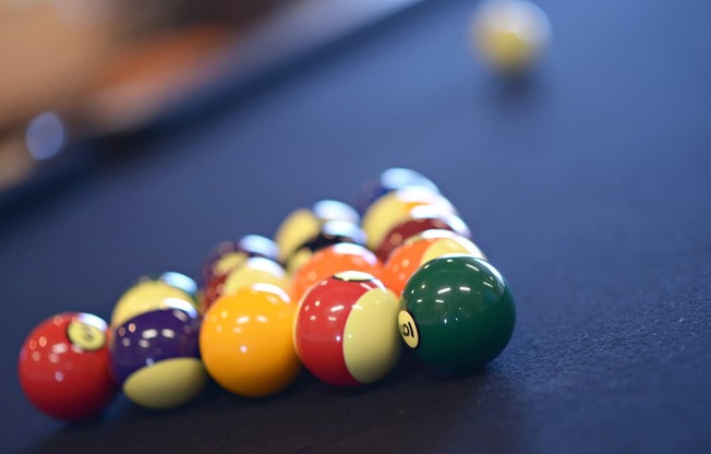 a pile of billiard balls on a pool table