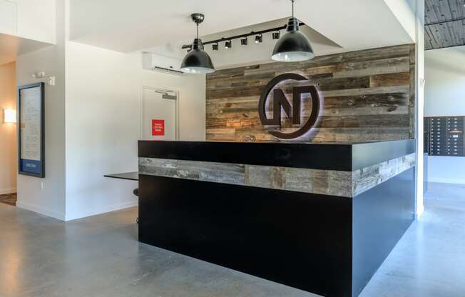 a reception desk with a reclaimed wood wall behind it