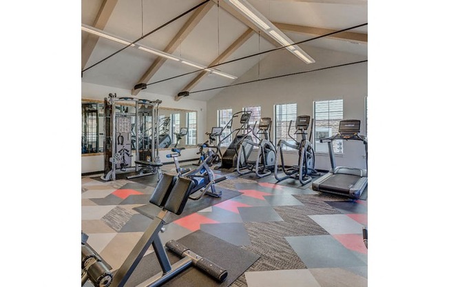 Luxury Apartments in Tigard OR - Expansive Fitness Center Featuring Various Gym Equipment