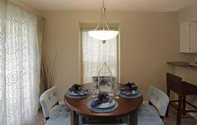 a dining room with a table and chairs and a chandelier