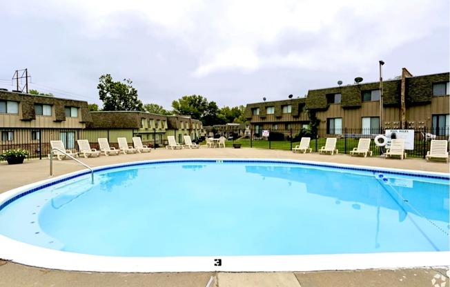 a swimming pool is shown in front of a hotel pool