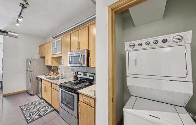 A modern kitchen with wooden cabinets and stainless steel appliances.