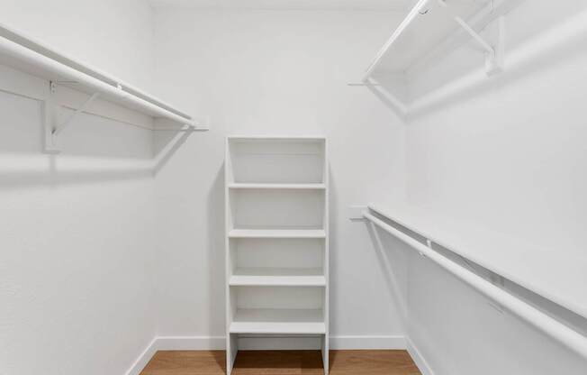 A white shelving unit in a white room.