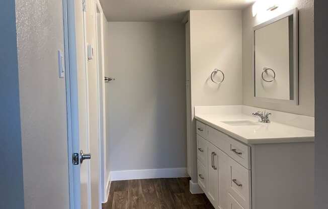 an empty bathroom with a sink and a mirror