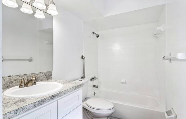 a bathroom with a sink toilet and a bath tub