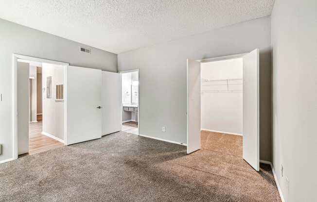 an empty living room with white walls and a carpeted floor