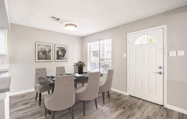 A dining room with a table set for six.