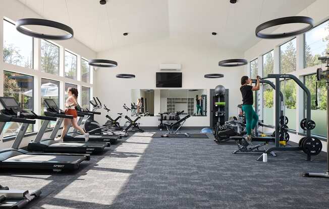 a large exercise room with treadmills and other exercise equipment