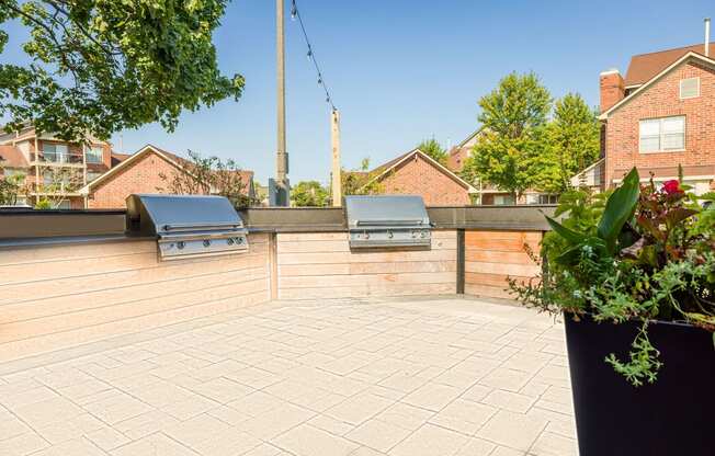 a patio with two barbecue grills on it