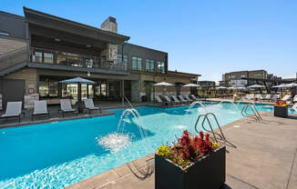 A pool area with a building in the background.