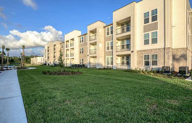 Apartment complex with a green lawn in front.