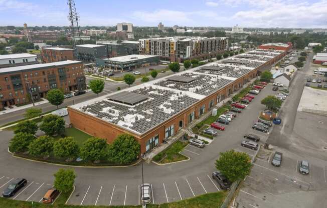 a large brick building with a lot of solar panels on top of it