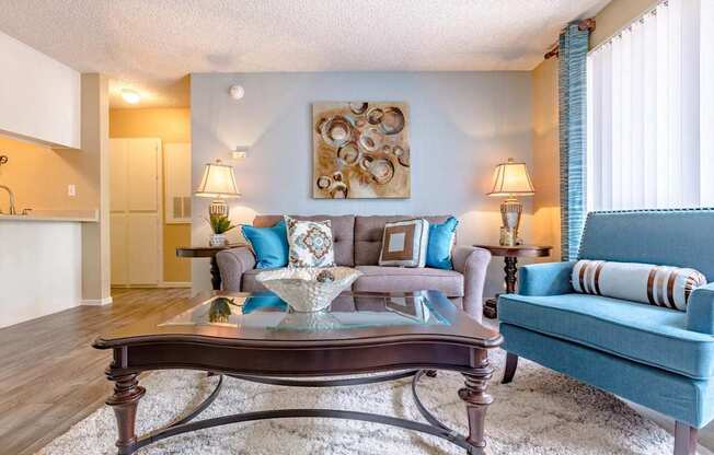 A living room with a blue couch and a coffee table.
