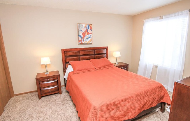 a bedroom with a bed and two night stands