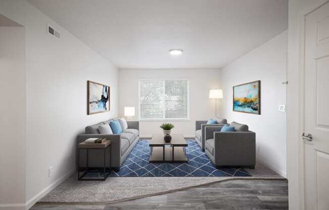 a living room with white walls and a blue rug