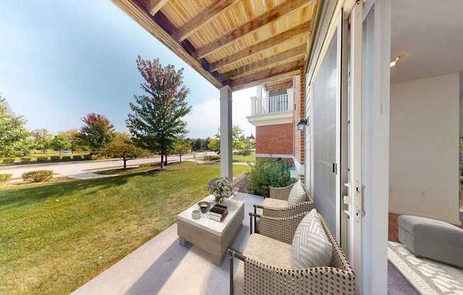 A patio with a couch and a table is shown.