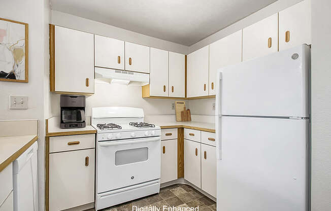 A kitchen with white appliances and cabinets at The Highlands Apartments in Elkhart, IN