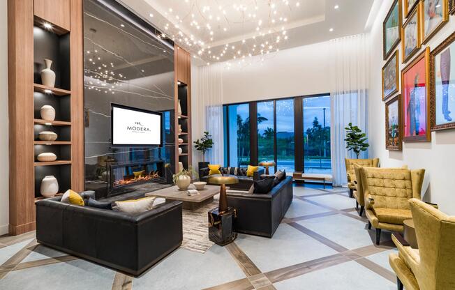 A social lounge at Modera Aventura, where sculptural lighting, curated art, and indoor-outdoor views reflect the energy and style of South Florida living.
