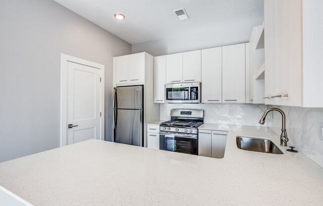 Kitchen with stainless steel appliances and white cabinets