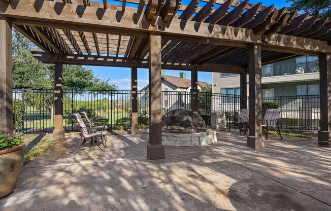 a patio with a fire pit and a pergola at The Fairways at Star Ranch, Hutto, Texas
