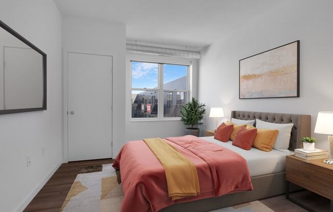 a bedroom with a bed and a window