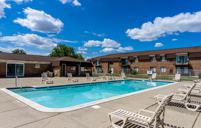 Swimming Pool and pool chairs at Warren Woods Apartments in Warren. Michigan