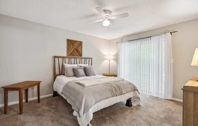 a bedroom with a bed and a ceiling fan