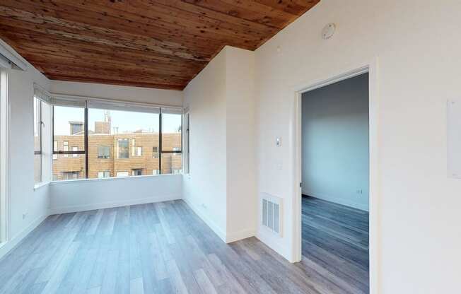 a bedroom with hardwood floors and a wooden ceiling