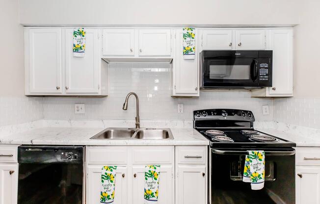 a stove top oven sitting inside of a kitchen