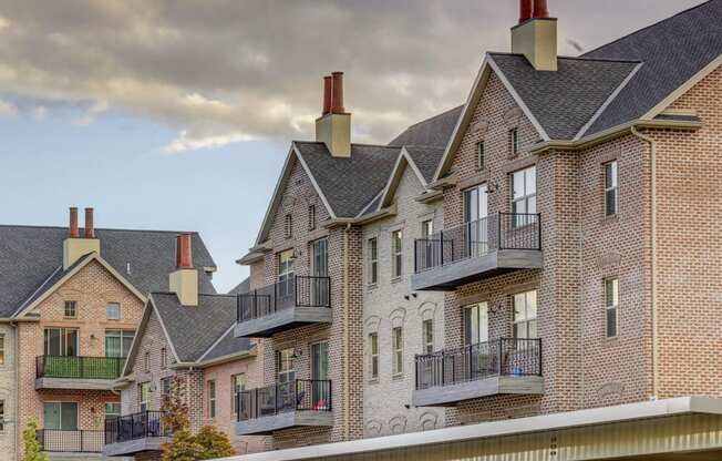 Top of brick apartment building with patios and chimneys