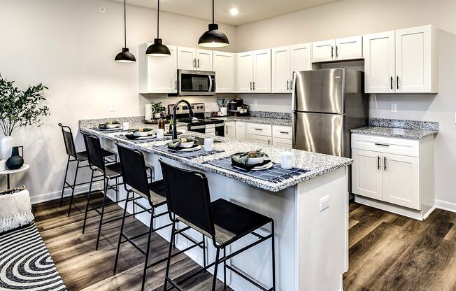 Studio, one and two bedroom apartment homes featuring stainless steel appliances, luxury vinyl floor, granite countertops, large closets and full-size washer and dryer at The Parker in Papillion, NE