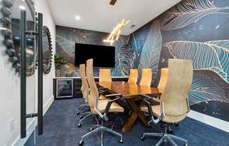 A conference room with a long table and chairs.